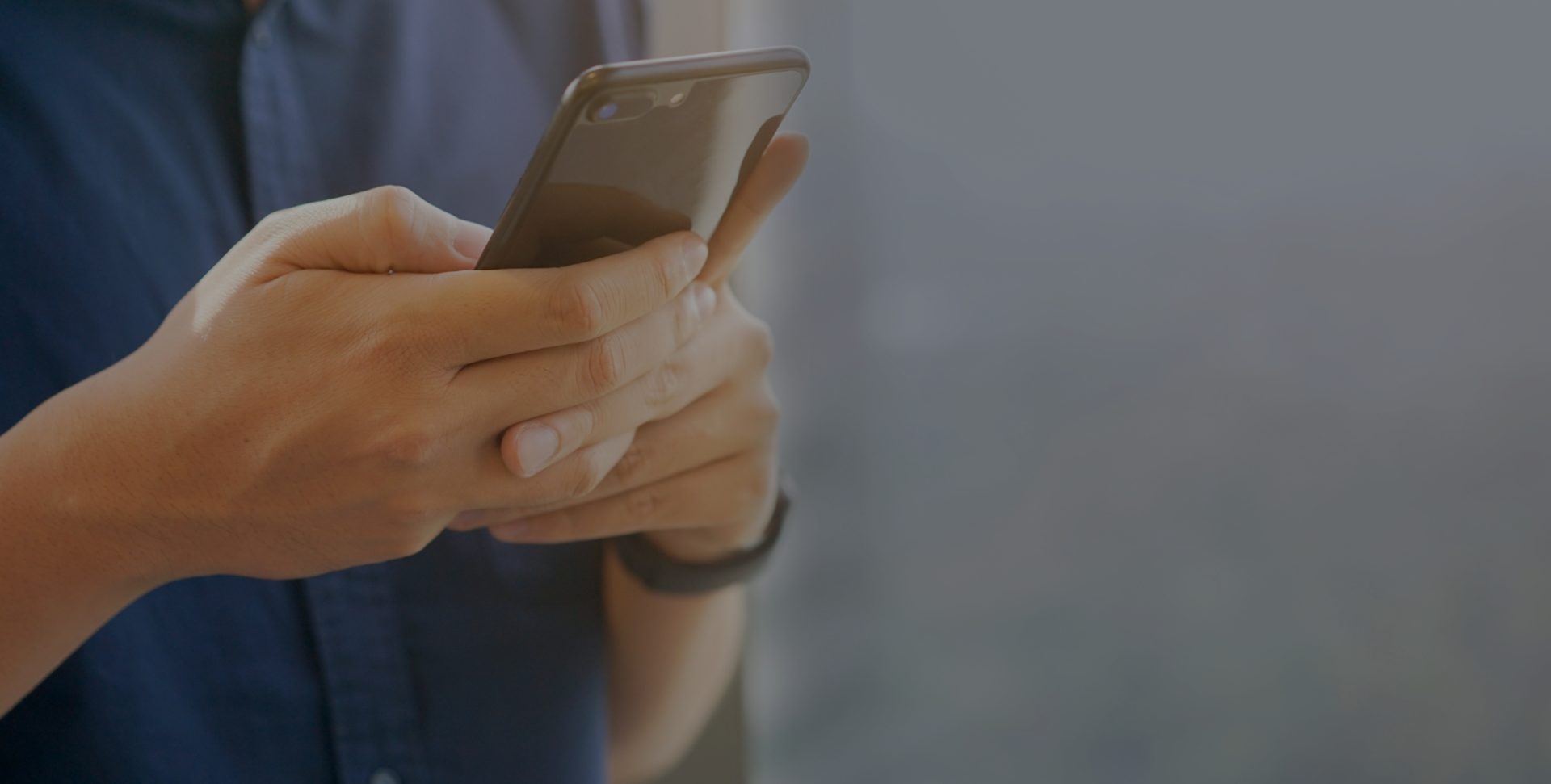 close up businessman holding smartphone for checking work or make appointment and using application for manage job or surf the internet at outside office , technology lifestyle concept